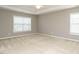 Bright bedroom with tray ceiling, neutral carpet, and ample natural light at 1113 Crendall Way, Wake Forest, NC 27587