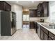 Open kitchen with stainless steel appliances and neutral countertops at 1113 Crendall Way, Wake Forest, NC 27587