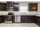 Modern kitchen with dark cabinets and stainless steel appliances at 1113 Crendall Way, Wake Forest, NC 27587