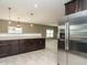 Open concept kitchen with stainless steel appliances and pendant lighting at 1113 Crendall Way, Wake Forest, NC 27587