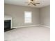 Comfortable living room with plush carpet, ceiling fan, and a cozy fireplace at 1113 Crendall Way, Wake Forest, NC 27587