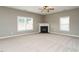 Spacious living room featuring plush carpet, fireplace, and ample natural light at 1113 Crendall Way, Wake Forest, NC 27587