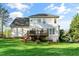View of the backyard and the deck with stairs of a two-story house on a sunny day at 1154 Smith Creek Way, Wake Forest, NC 27587