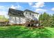 A beautiful view of the backyard of a two-story house with a deck on a bright day at 1154 Smith Creek Way, Wake Forest, NC 27587