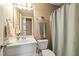 Well-lit bathroom featuring a shower/tub, mirror, and a white basin sink at 1154 Smith Creek Way, Wake Forest, NC 27587