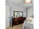 Bright bedroom features carpet floors, a ceiling fan and a dresser with mirror at 1154 Smith Creek Way, Wake Forest, NC 27587