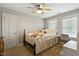 Cozy bedroom featuring carpet floors, a ceiling fan and natural light at 1154 Smith Creek Way, Wake Forest, NC 27587