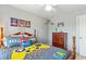 Stylish bedroom with themed bedding, carpet floors, and classic wooden dresser at 1154 Smith Creek Way, Wake Forest, NC 27587