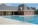 Inviting community pool with clear blue water and ample seating area, perfect for relaxation and recreation at 1154 Smith Creek Way, Wake Forest, NC 27587