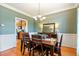 Traditional dining room with hardwood floors, decorative chandelier, and wainscoting at 1154 Smith Creek Way, Wake Forest, NC 27587