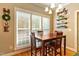 Bright dining room features hardwood floors, modern lighting, and large windows at 1154 Smith Creek Way, Wake Forest, NC 27587