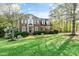 Beautiful two-story brick home showcasing lush green lawn and mature trees at 1154 Smith Creek Way, Wake Forest, NC 27587