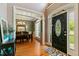 Elegant foyer with hardwood floors and decorative front door that leads to dining area at 1154 Smith Creek Way, Wake Forest, NC 27587
