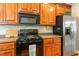 A well-equipped kitchen boasts updated appliances, wooden cabinetry, and ample counter space at 1154 Smith Creek Way, Wake Forest, NC 27587