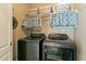 Functional laundry room with modern washer and dryer units, and storage at 1154 Smith Creek Way, Wake Forest, NC 27587