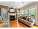 Comfortable living room featuring a fireplace, mantle and plenty of natural light at 1154 Smith Creek Way, Wake Forest, NC 27587