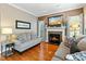 Cozy living room features a fireplace with mounted tv, hardwood floors, and neutral tones at 1154 Smith Creek Way, Wake Forest, NC 27587