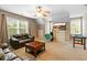 Bright living room with a ceiling fan, comfortable couches, a TV and a mini pool table at 1154 Smith Creek Way, Wake Forest, NC 27587