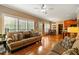 Open living room with bright windows, hardwood floors, and access to dining area at 1154 Smith Creek Way, Wake Forest, NC 27587