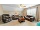 Spacious living room with three leather couches, coffee table, and natural light at 1154 Smith Creek Way, Wake Forest, NC 27587