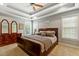 Bright main bedroom with trey ceiling, plush carpet, windows, and stylish decor at 1154 Smith Creek Way, Wake Forest, NC 27587