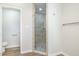 Tiled glass shower and toilet in a bright bathroom at 1309 N Holland Rd, Fuquay Varina, NC 27526