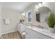 Bright bathroom featuring double sinks with marble countertops and modern lighting at 1309 N Holland Rd, Fuquay Varina, NC 27526