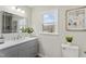 Updated bathroom with gray vanity, modern fixtures, and a window view at 1309 N Holland Rd, Fuquay Varina, NC 27526