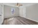 Bright bedroom with wood floors, a window view, and a ceiling fan at 1309 N Holland Rd, Fuquay Varina, NC 27526