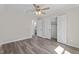 Bright bedroom with wood floors, ceiling fan, and a bathroom doorway at 1309 N Holland Rd, Fuquay Varina, NC 27526