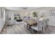 Open-concept dining area with a ceiling fan, table, and chairs leading to the living room at 1309 N Holland Rd, Fuquay Varina, NC 27526