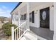 Inviting front porch with classic white columns, black shutters and a decorative front door at 1309 N Holland Rd, Fuquay Varina, NC 27526
