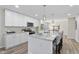 Bright kitchen features a large granite island with seating and modern appliances. Opens to living room at 1309 N Holland Rd, Fuquay Varina, NC 27526