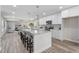 Bright kitchen features a large granite island with seating and modern appliances. Opens to living room at 1309 N Holland Rd, Fuquay Varina, NC 27526