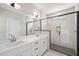 Modern bathroom featuring double sink vanity and tiled shower with glass enclosure at 140 Pilot Ridge Rd, Zebulon, NC 27597