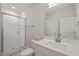 Bathroom featuring a glass shower, tile, light countertop, a sink and a large mirror at 140 Pilot Ridge Rd, Zebulon, NC 27597