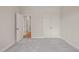 Empty bedroom features carpet flooring, a view into the hallway, and double closets at 140 Pilot Ridge Rd, Zebulon, NC 27597