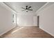Bright bedroom with tray ceiling, neutral paint, wood floor, and natural light at 140 Pilot Ridge Rd, Zebulon, NC 27597
