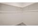 Empty closet with wood hanging rod and gray carpeting at 140 Pilot Ridge Rd, Zebulon, NC 27597
