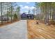 Stately two-story home with blue siding, stone accents, a long driveway, and picturesque natural surroundings at 140 Pilot Ridge Rd, Zebulon, NC 27597