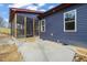 Side exterior view of the home showing a screened porch and patio area at 140 Pilot Ridge Rd, Zebulon, NC 27597