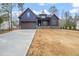 Charming two-story home featuring blue siding, a stone foundation, a driveway, and a two-car garage at 140 Pilot Ridge Rd, Zebulon, NC 27597