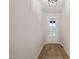 Bright hallway with wood-look floors leads to a front door with glass and a modern ceiling light at 140 Pilot Ridge Rd, Zebulon, NC 27597