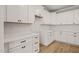 Bright kitchen with modern white cabinets, stone countertops, and white tile backsplash at 140 Pilot Ridge Rd, Zebulon, NC 27597