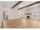 Spacious living room with wood-look floors, a fireplace, and a doorway to another room at 140 Pilot Ridge Rd, Zebulon, NC 27597