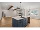 Spacious living room featuring an island, fireplace, wood beams, and natural lighting at 140 Pilot Ridge Rd, Zebulon, NC 27597
