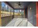 Enclosed porch with stained wood trim and ceiling fan at 140 Pilot Ridge Rd, Zebulon, NC 27597