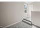 Carpeted stairs leading to a hallway featuring natural light from a double-hung window at 140 Pilot Ridge Rd, Zebulon, NC 27597