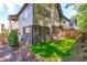 Exterior of home with black brick, artificial turf, and a wooden deck surrounded by privacy fence at 1406 Lyon St # 101, Raleigh, NC 27608