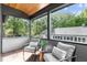 Cozy covered balcony with comfortable seating and wood decking at 1406 Lyon St # 101, Raleigh, NC 27608